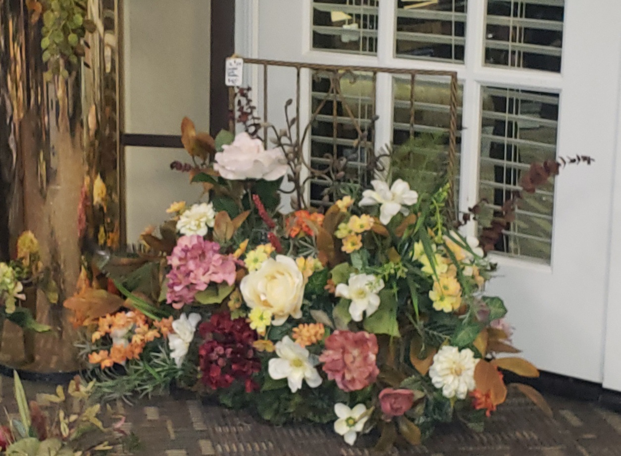 Lush floral arrangement styled by Allure Interior Design at the shop entrance