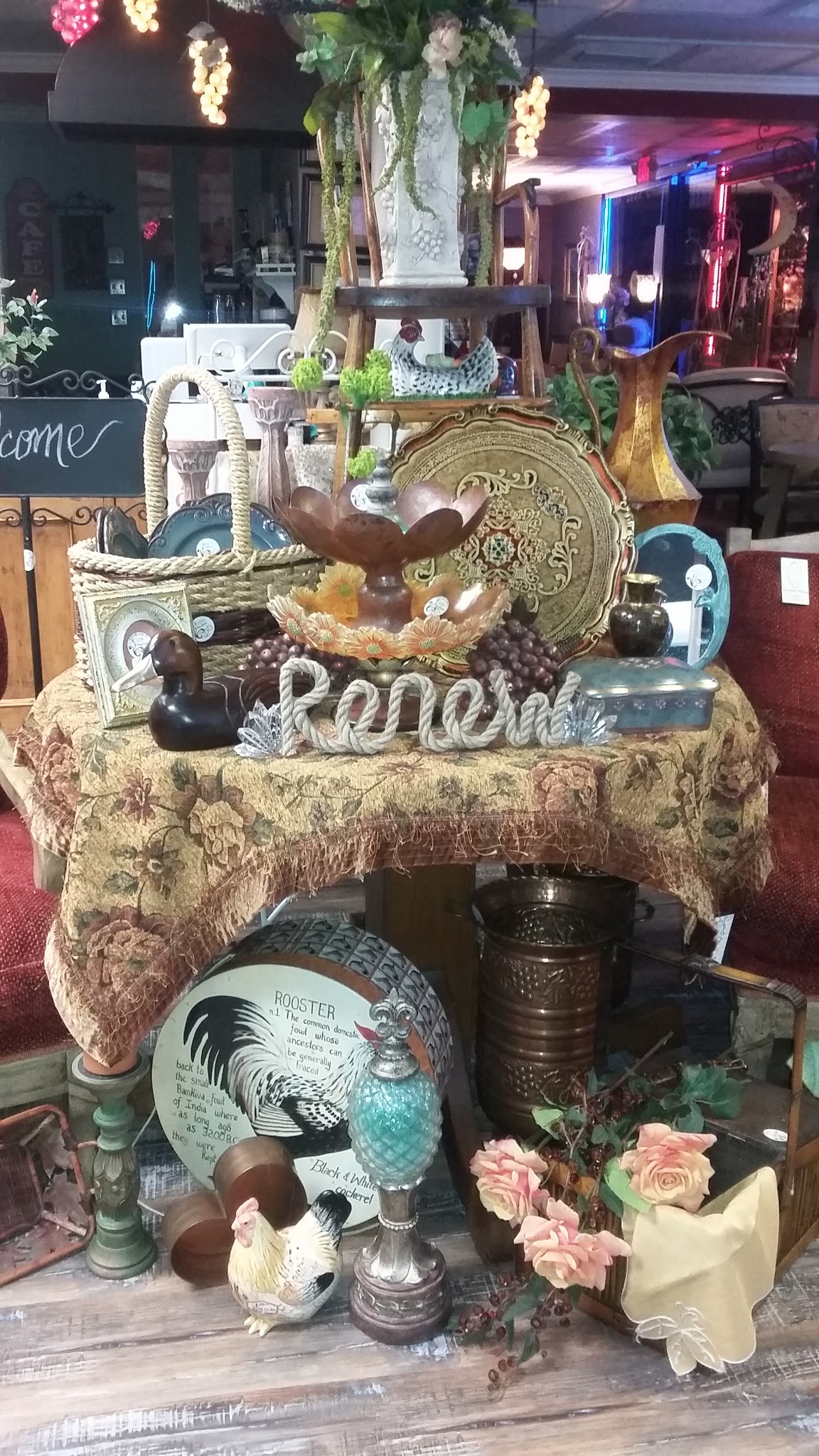 Styled vignette of vintage décor on a tapestry-draped table